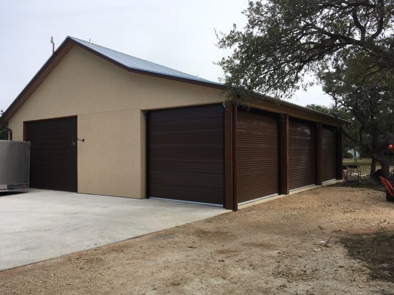 Brown Roll-up Doors installed on small commercial building