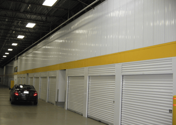 Drive-thru self-storage facility with white roll up unit doors