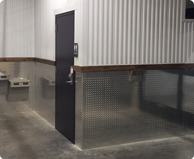 Diamond plate around bathroom door at self storage facility