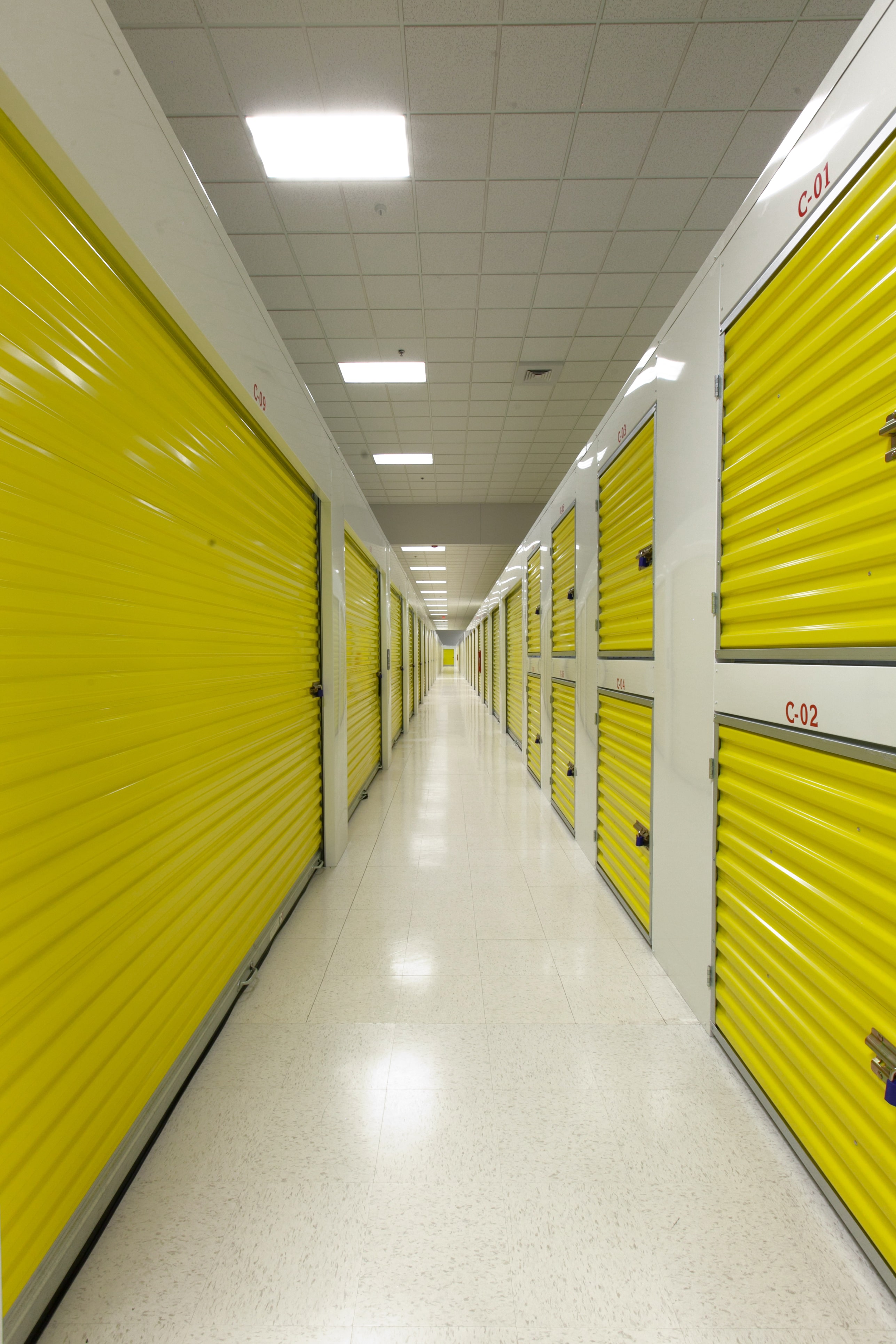 Janus hallway system with yellow roll-up doors and lockers
