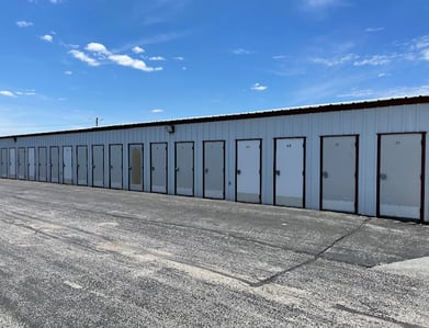 Several old and rotting swing doors at Farner Storage