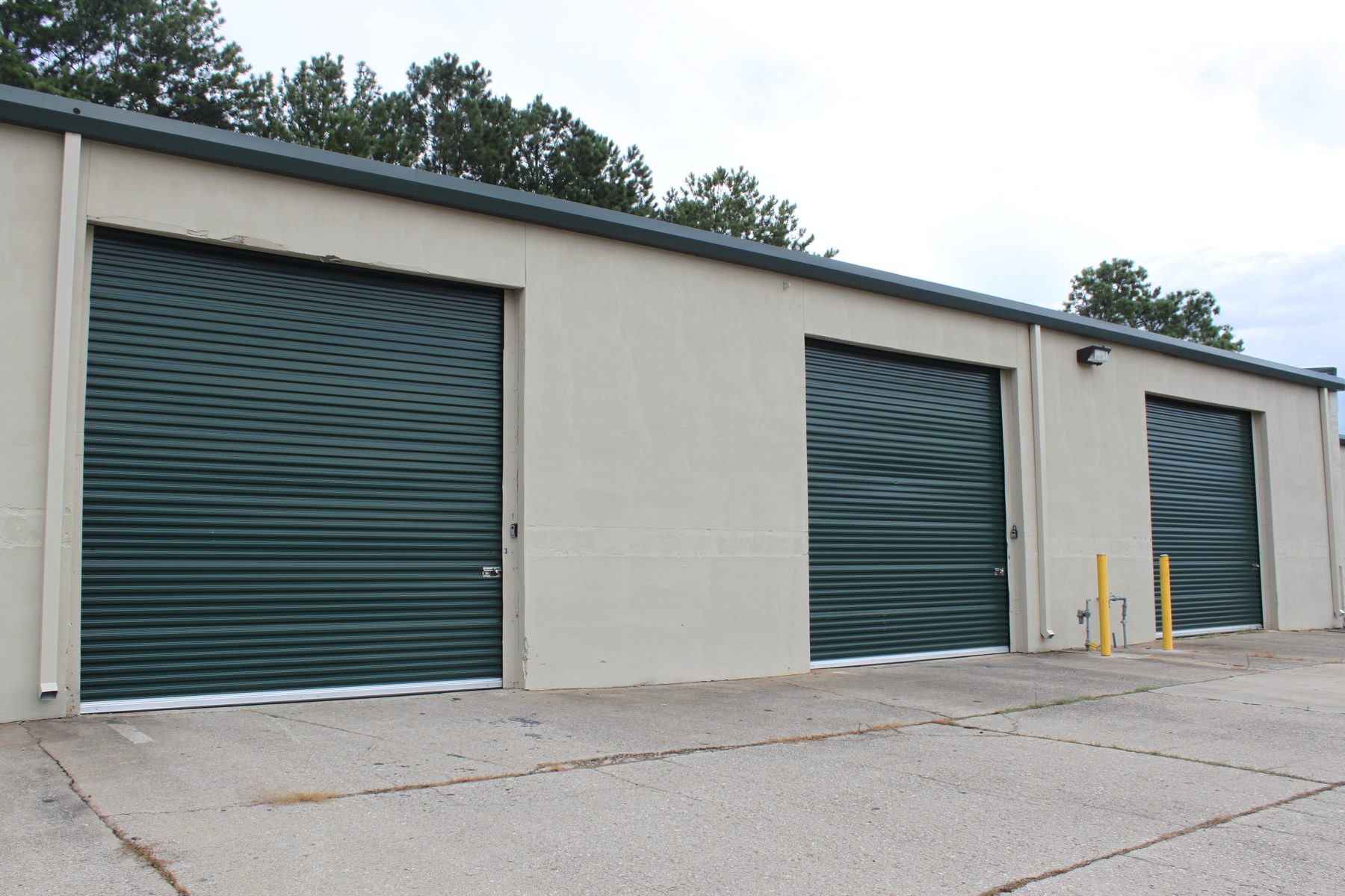 Commercial building with three dark gray Janus 2000 Series doors