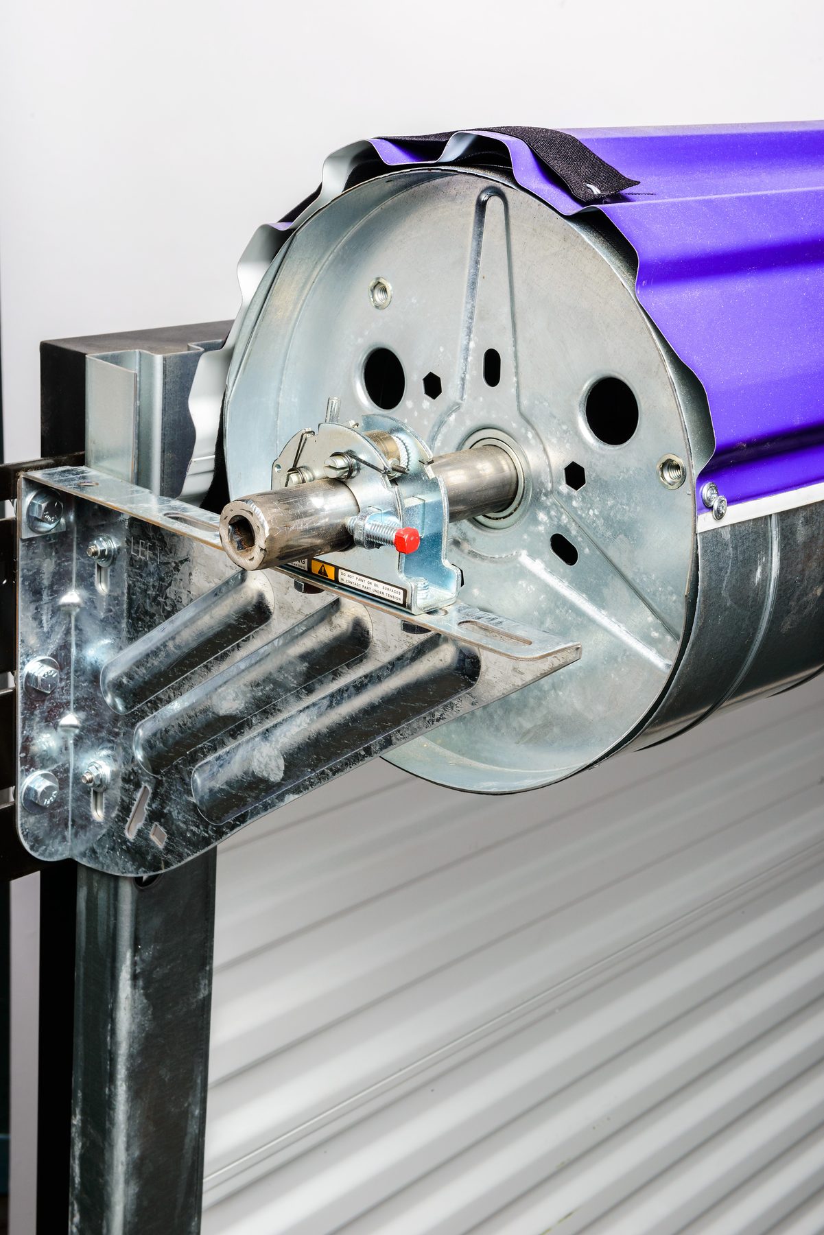 Close-up of the bracket and drum assembly on a Janus 2500 Series commercial door