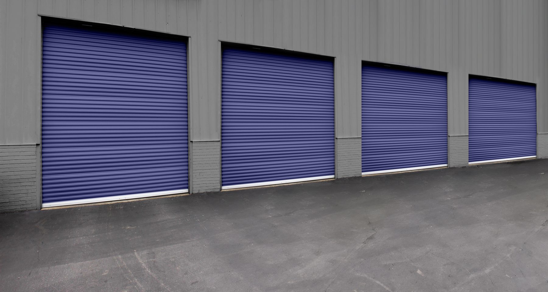 Row of Cobalt Blue Janus 3100 Series wind-load doors