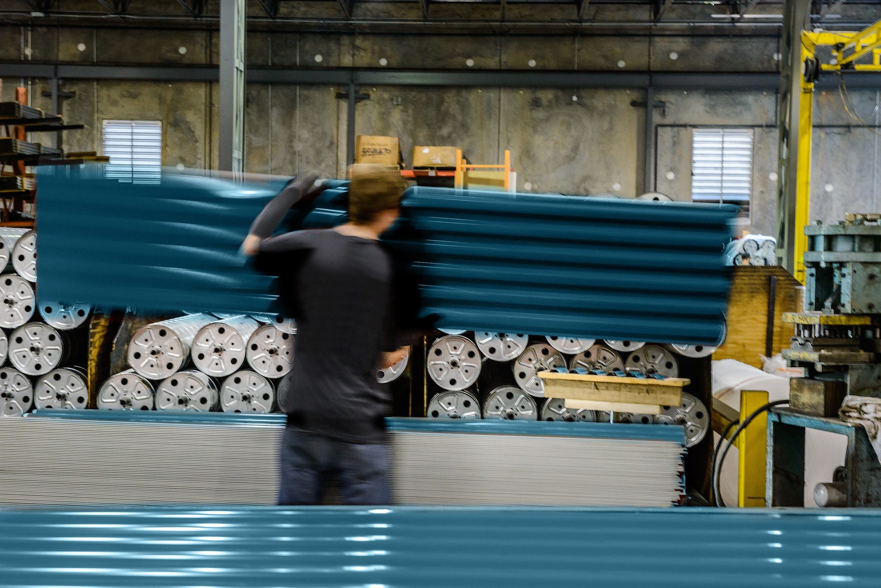 Janus team member carrying a blue door curtain