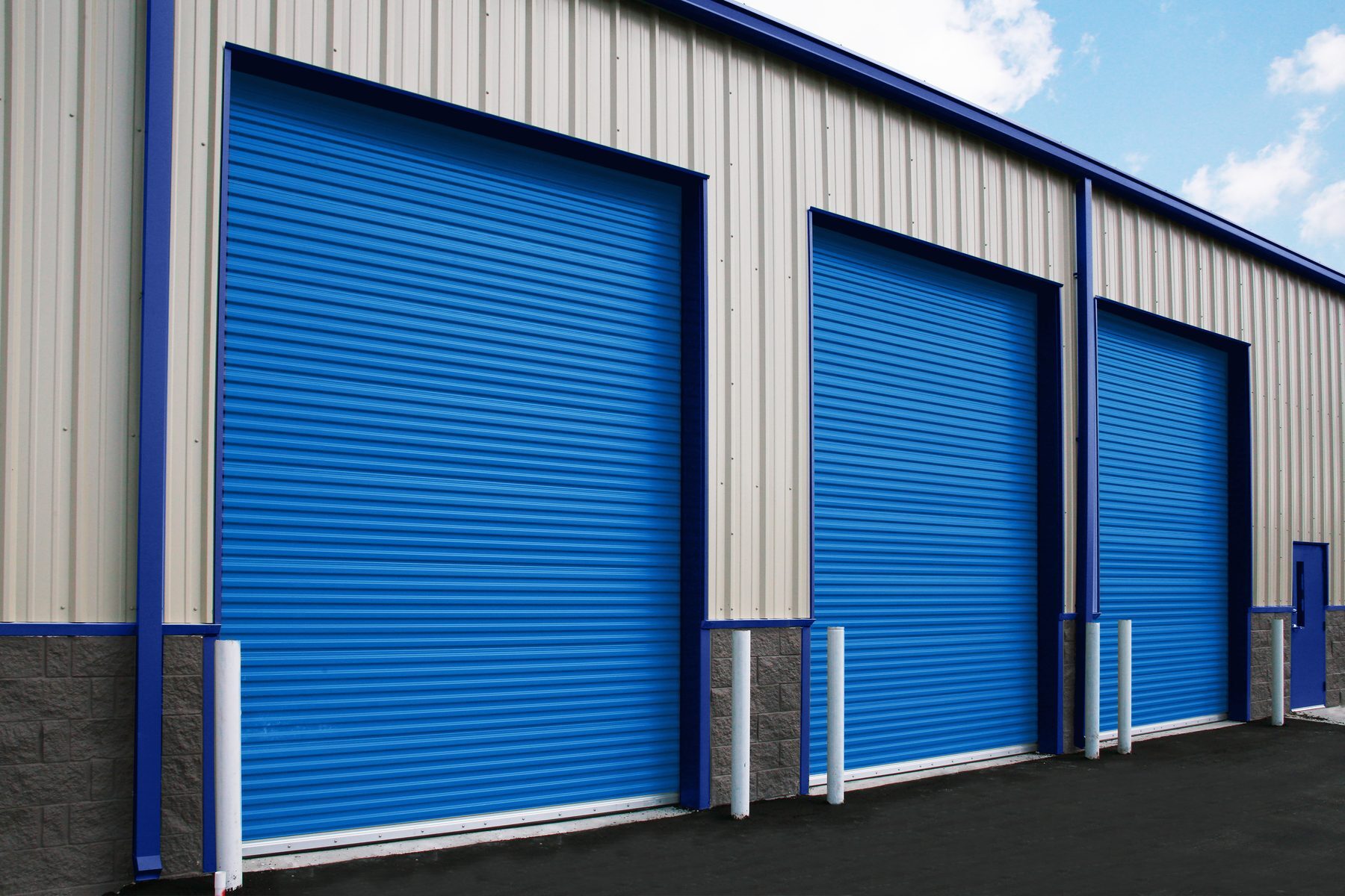 Royal Blue Janus commercial sheet doors on a metal warehouse