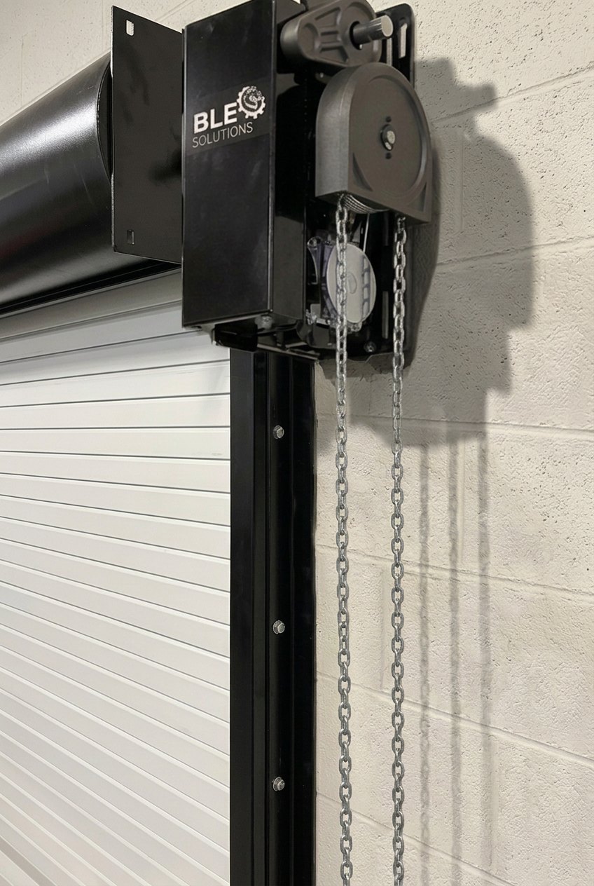 BLE Medium Duty Operator mounted beside a white roll-up door