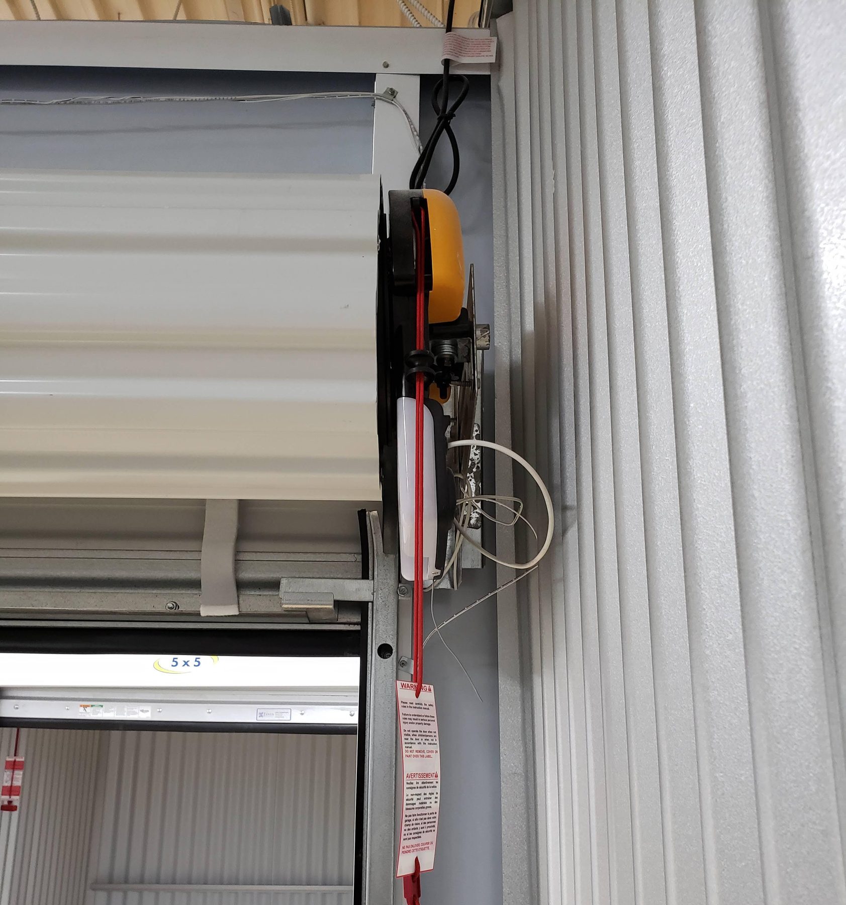 Easy Roller 14 operator beside an open self-storage unit door