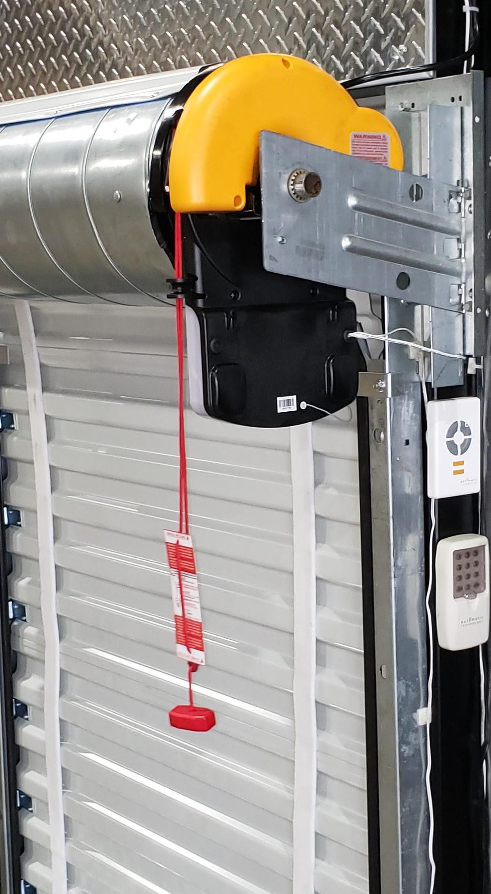 Easy Roller 14 operator on a self-storage unit door with a wall station and keypad