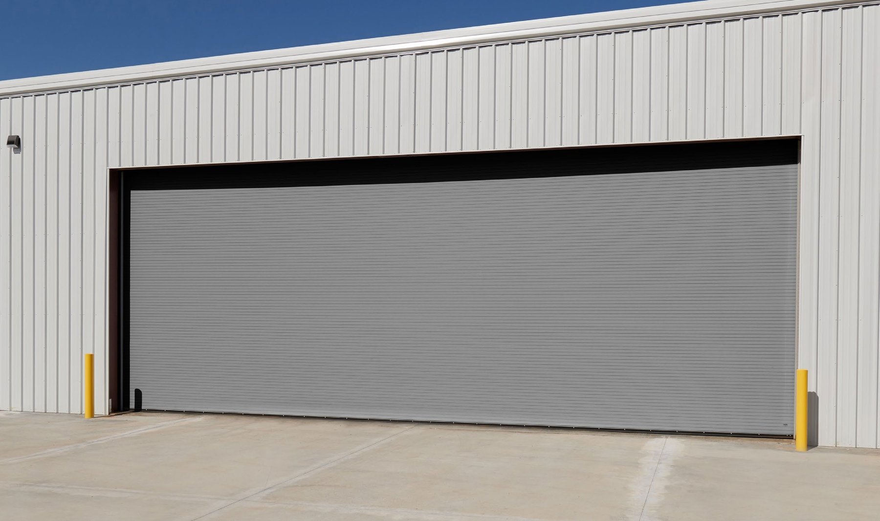 Janus 400 Series gray heavy duty rolling service door on a steel building