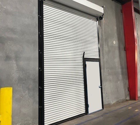 Janus 400 Series white rolling service door at a loading dock