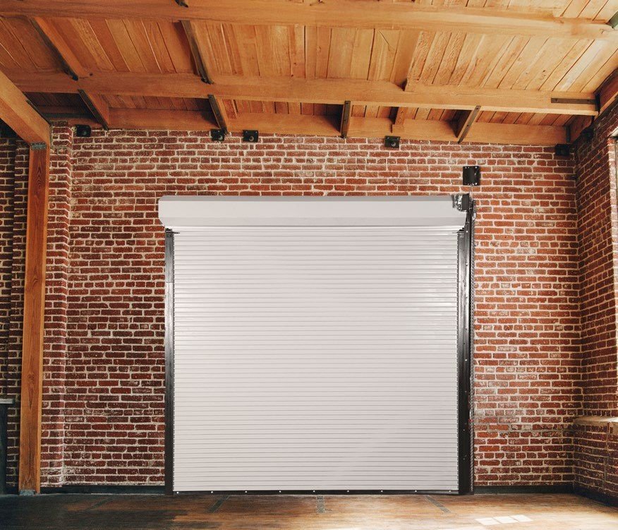 Janus 500 Series white rolling fire door in a brick warehouse wall