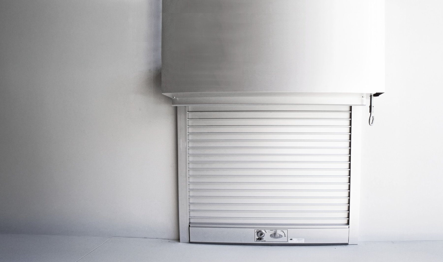Janus 700 Series white counter shutter with hood above a service counter
