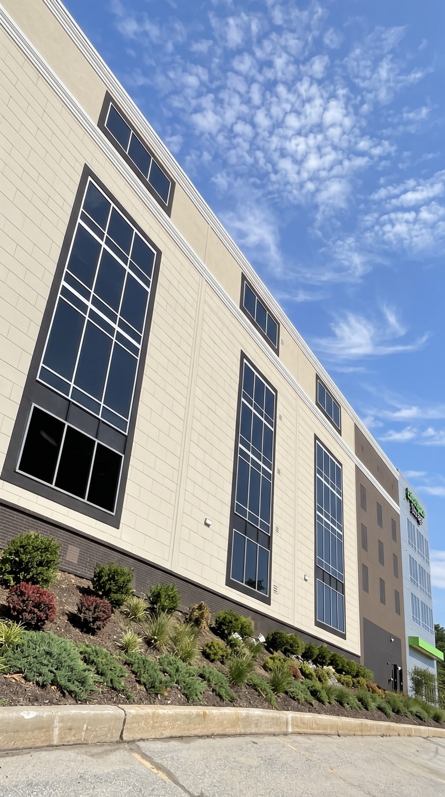 Angled view of a multi-story facility with tall faux windows
