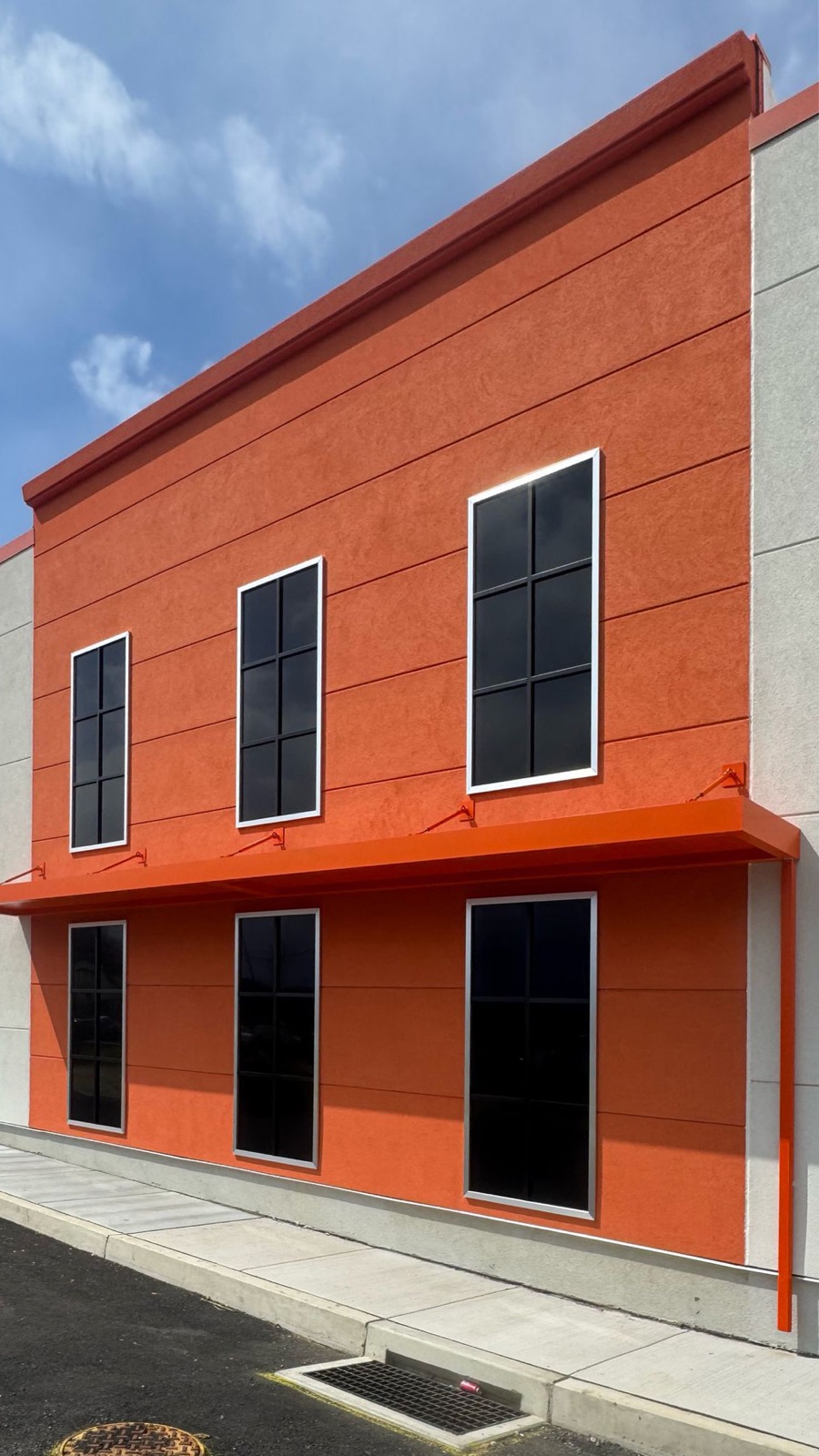Orange two-story facade with faux windows on both levels