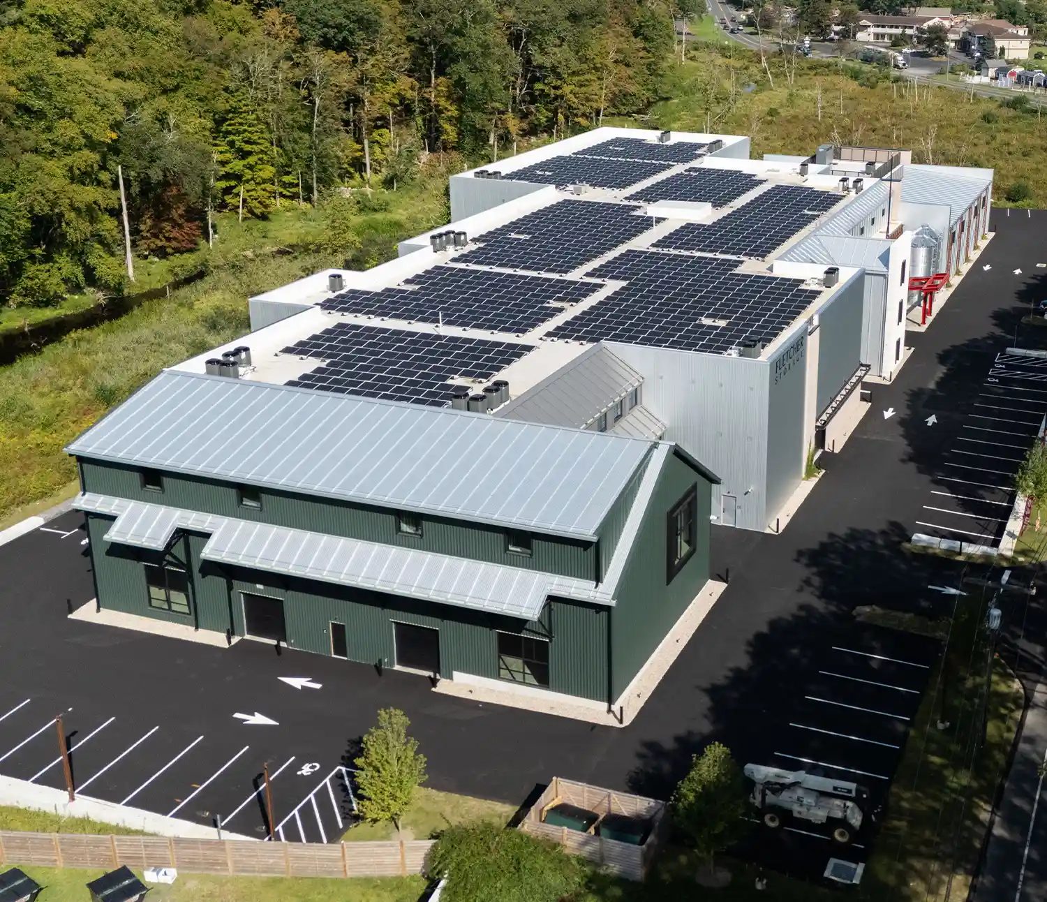 Aerial view of Fletcher Storage in Redding, CT, with solar panels on the roof