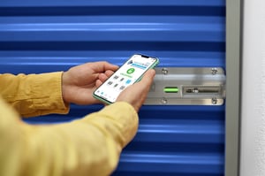 Tenant unlocking a Nokē Infinitē smart lock with the Nokē app on a smartphone