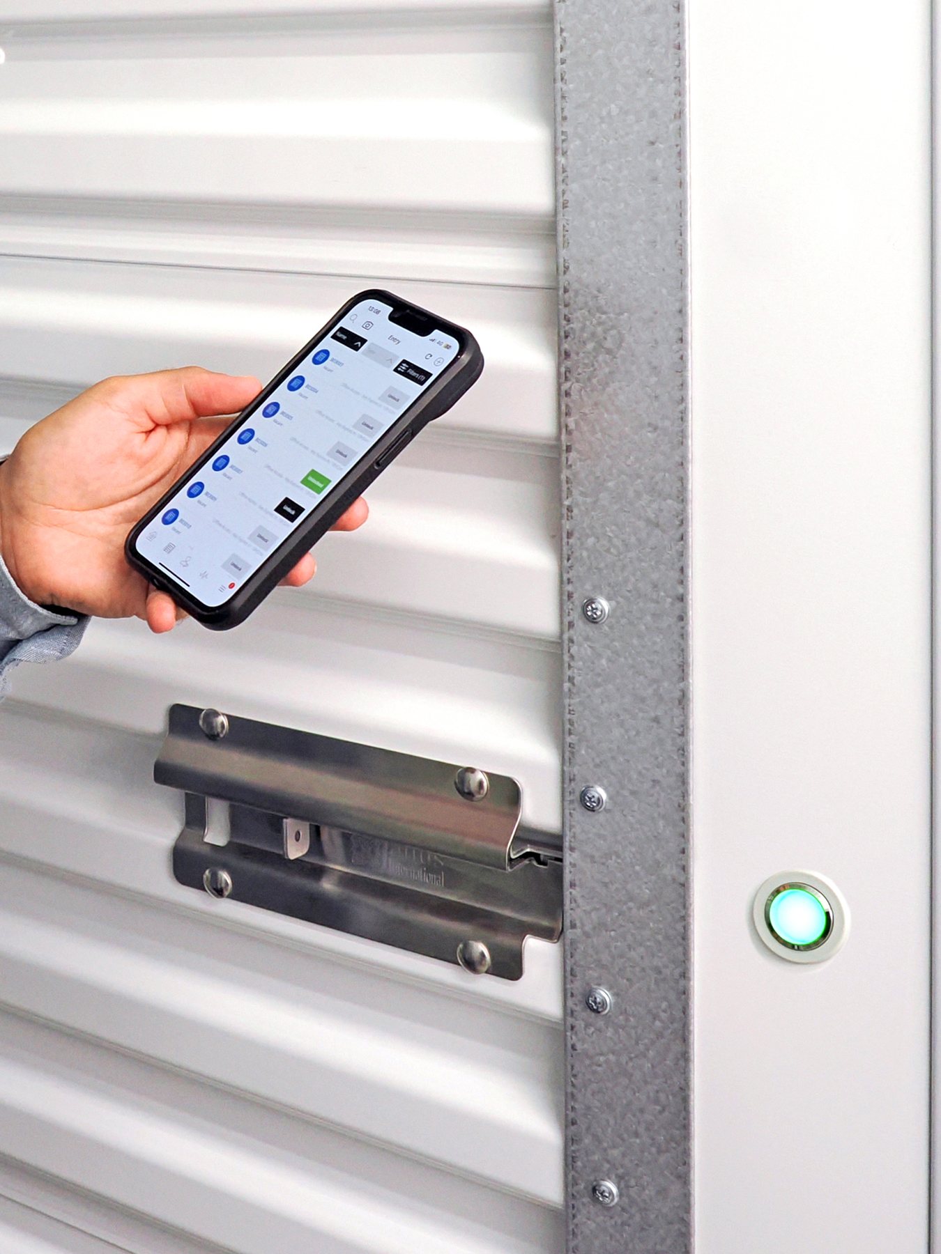Close-up of a tenant opening a Nokē Ion smart lock with the Nokē app, green LED lit beside the door