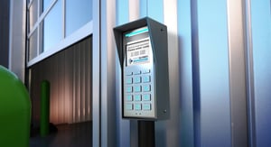 Nokē Screen smart keypad mounted on a bollard at a self-storage facility