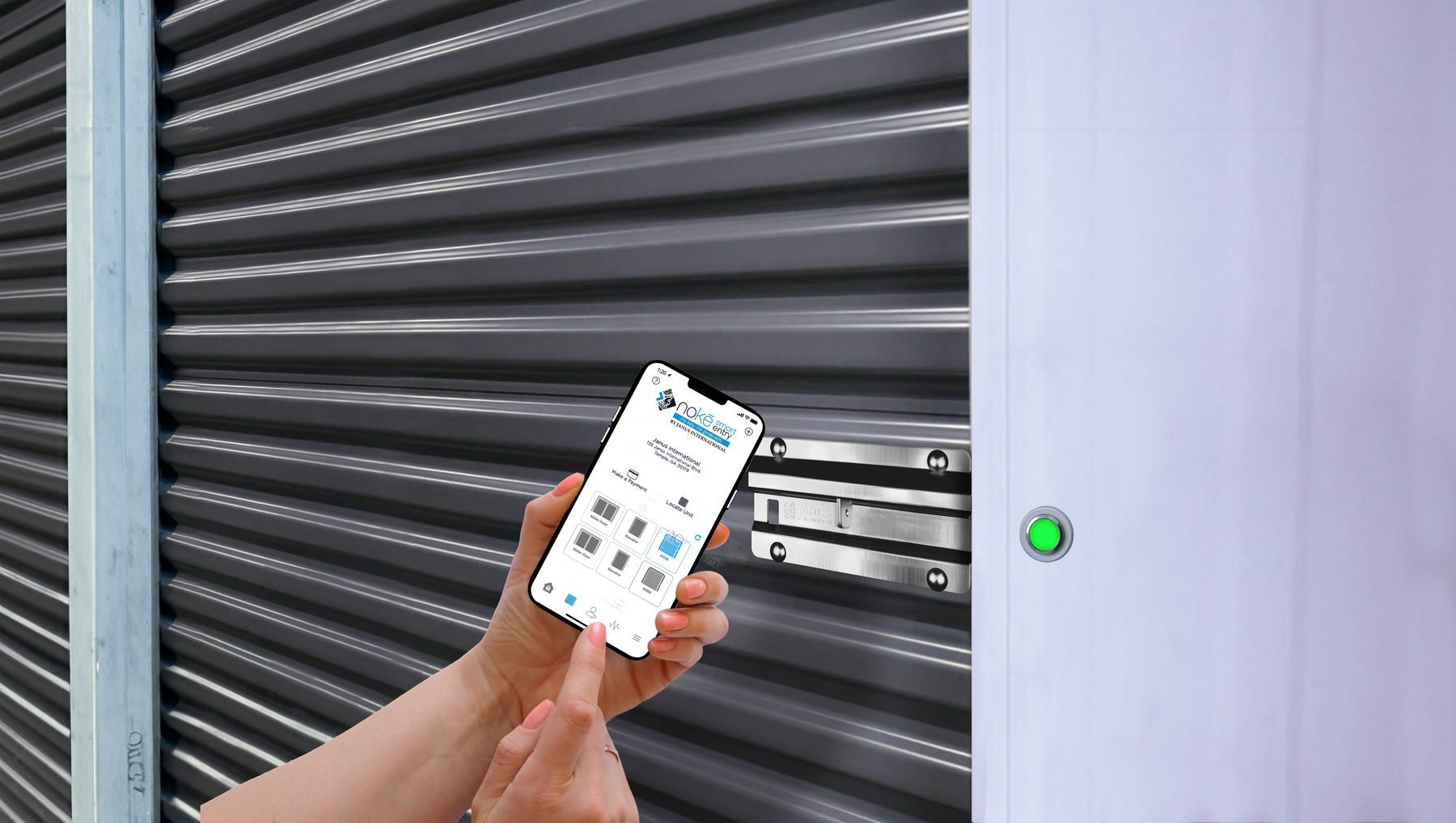 Tenant unlocking a Nokē Ion smart lock on a dark gray Janus door at Swift Storage, with a green LED beside the door