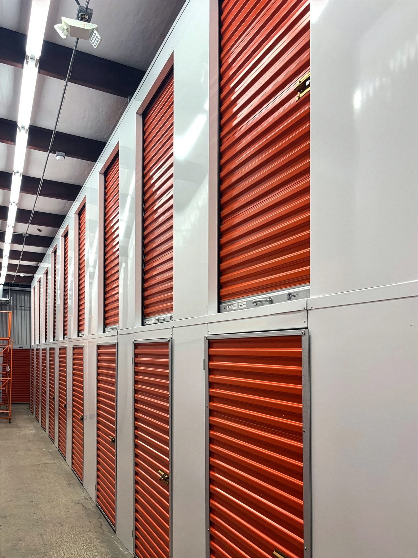 Interior self-storage hallway reskinned with stacked red Janus doors