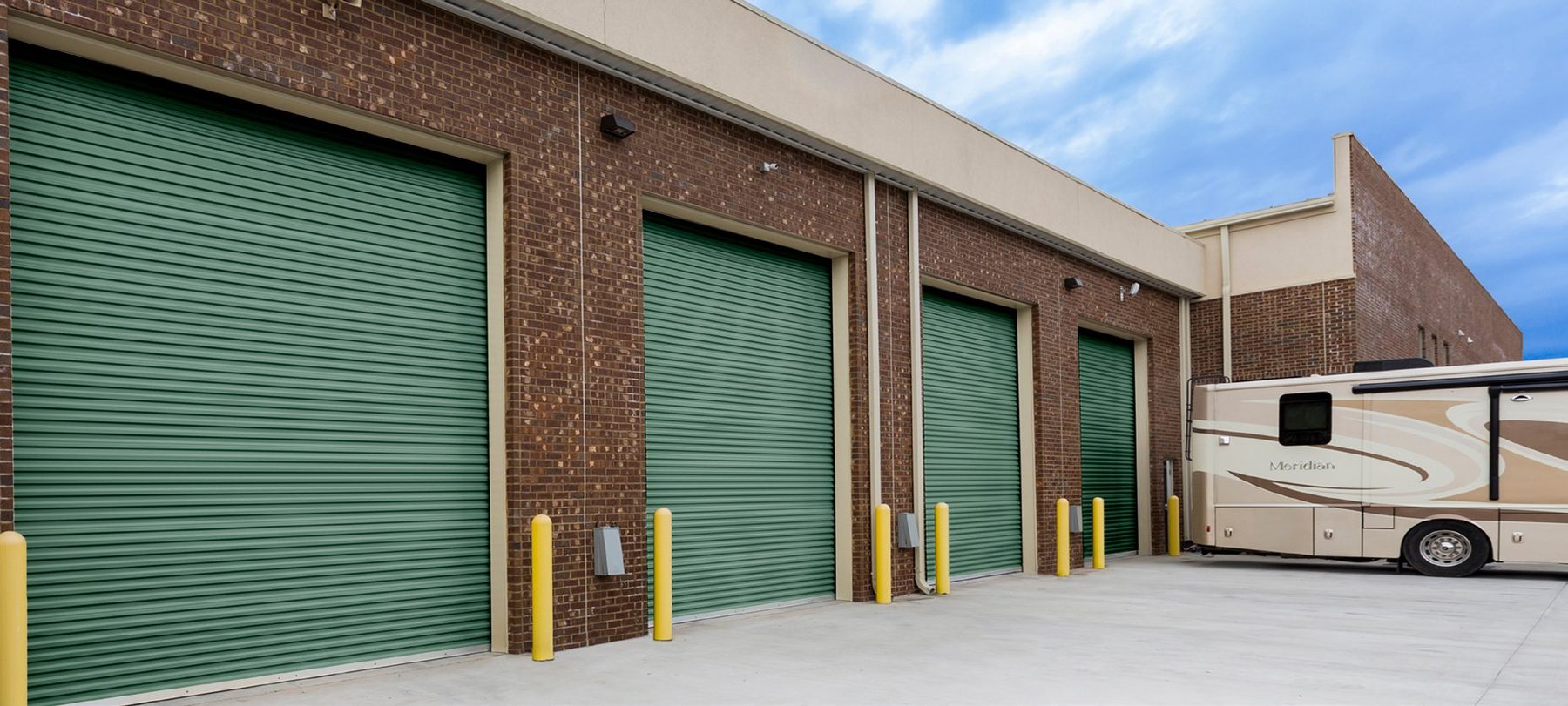 Green Janus rolling steel service doors at a loading dock