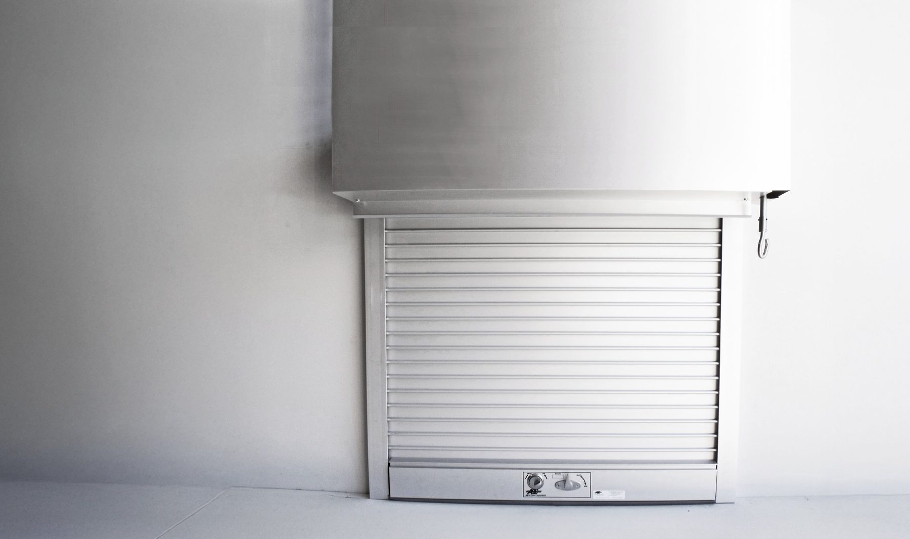 Closed white Janus 700 Series counter shutter under a hood