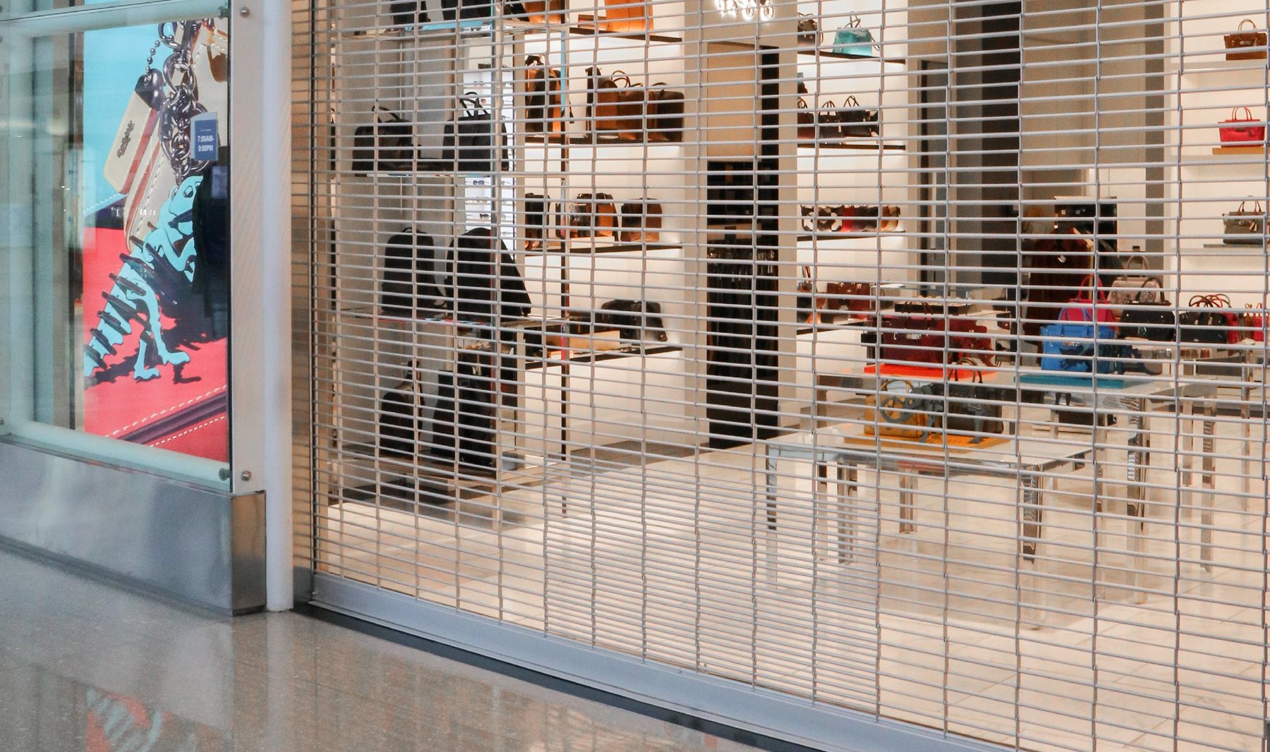 Janus 800 Series rolling grille closed across a retail storefront