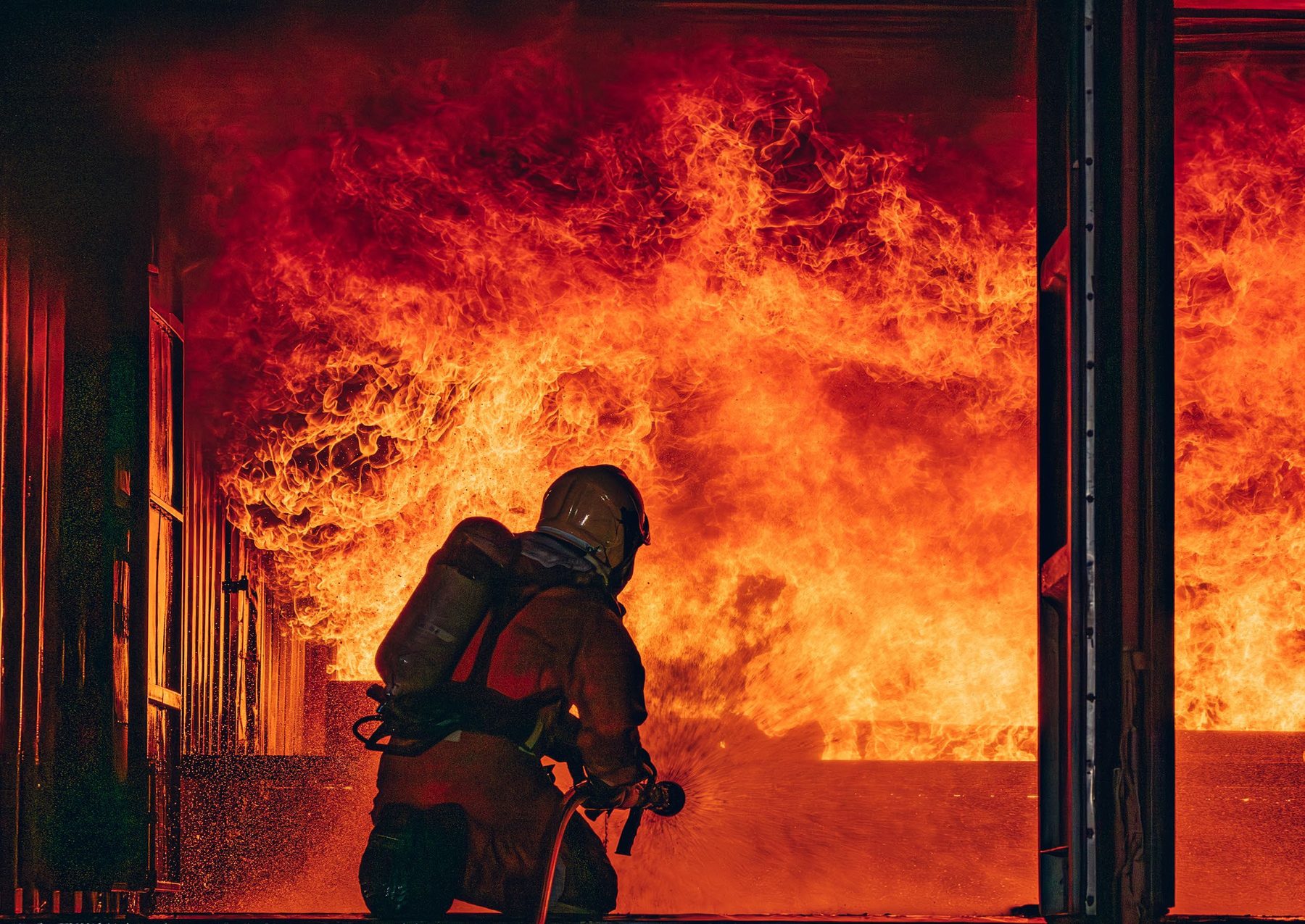 Firefighter in front of a Janus rolling fire door
