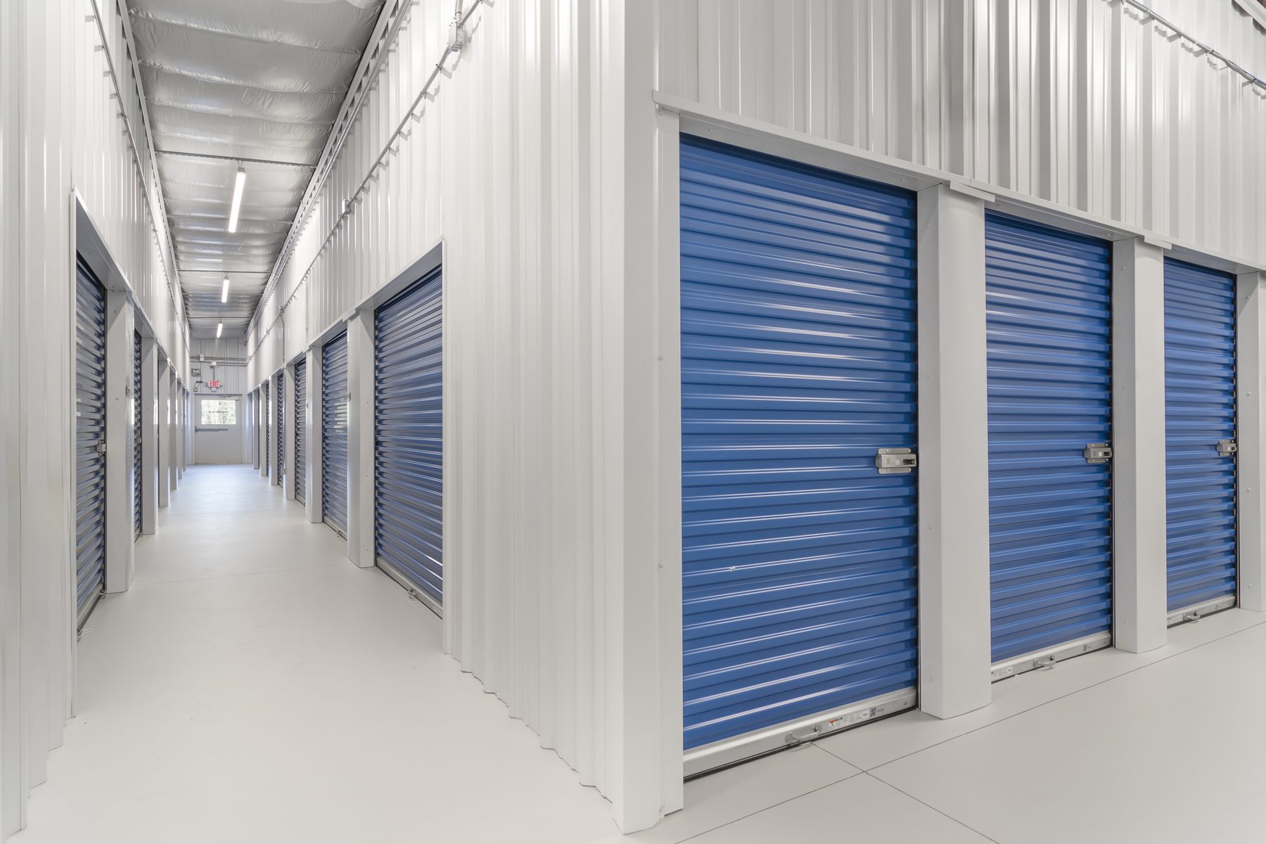 Interior hallway with blue Janus 650 Series roll-up doors