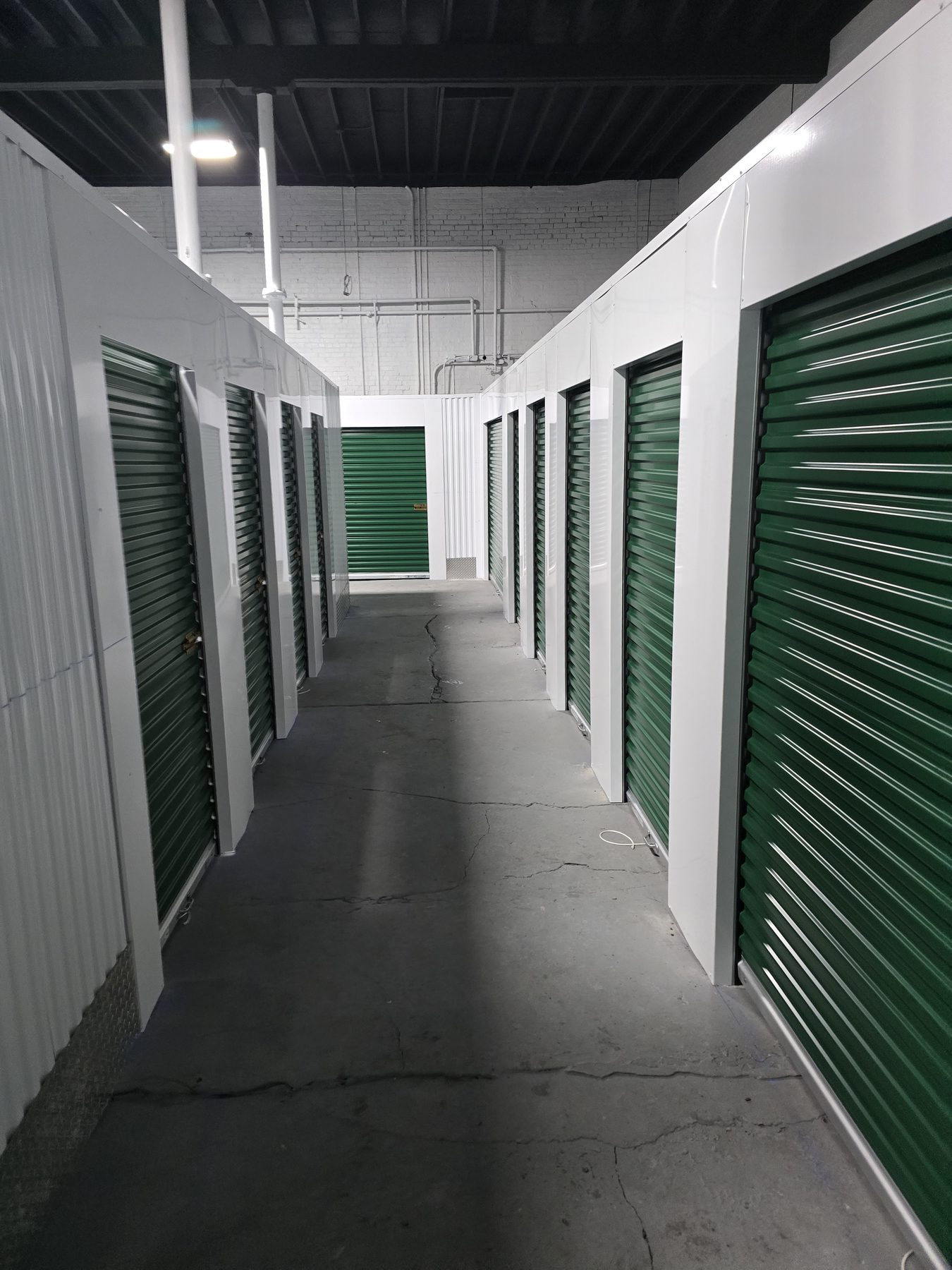 Interior self-storage hallway lined with Evergreen Janus roll-up doors