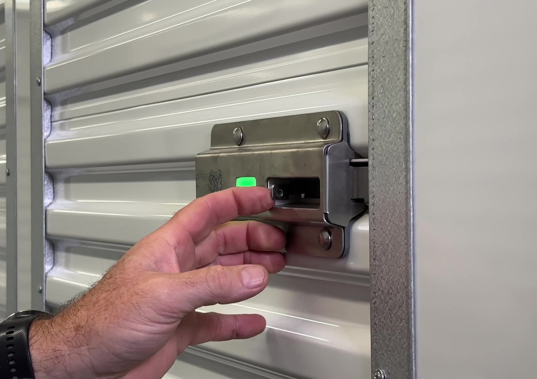 Tenant unlocking a Nokē smart lock with a green LED on a Janus locker door