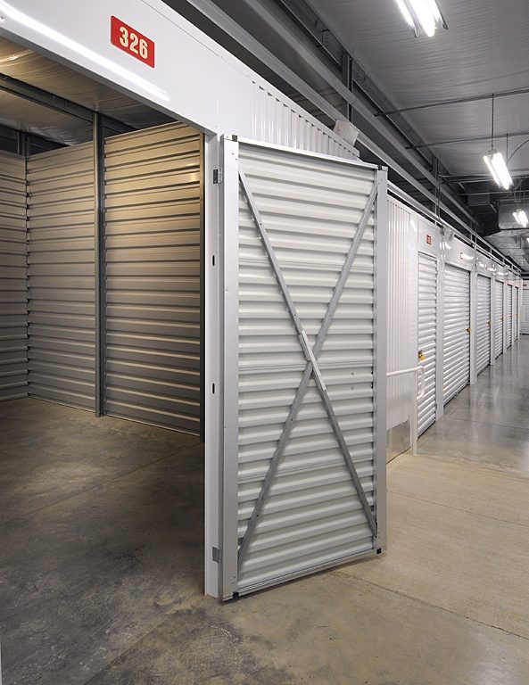 Open Janus swing door with X-bracing inside a self-storage unit
