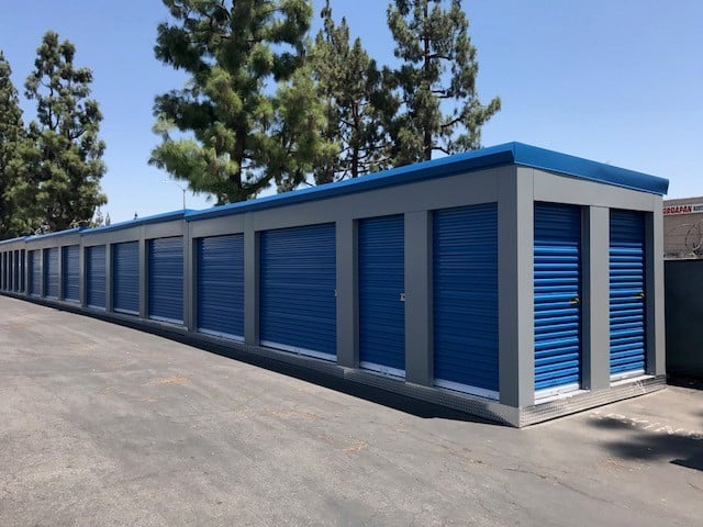 blue MASS relocatable storage units with trees in the background