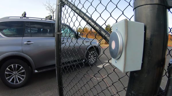 A car driving through a smart entry gate.