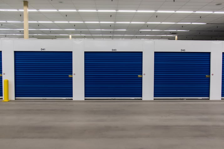 Row of blue Janus doors in self-storage unit.
