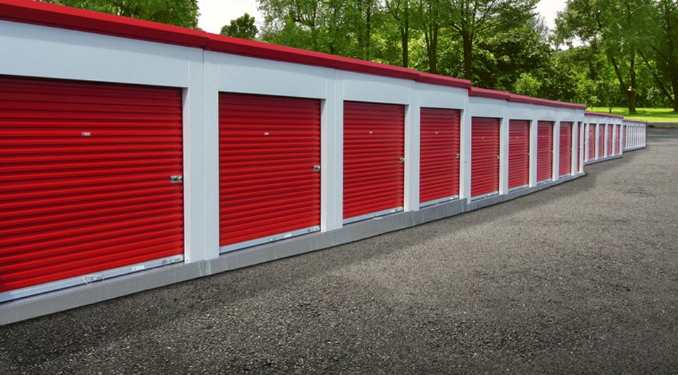 Image of portable storage unit buildings with red self storage doors