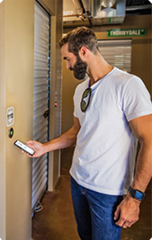 Man using Noke Smart Entry system to unlock storage unit