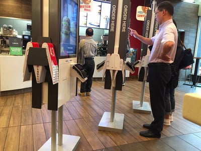 man using a kiosk at mcdonalds