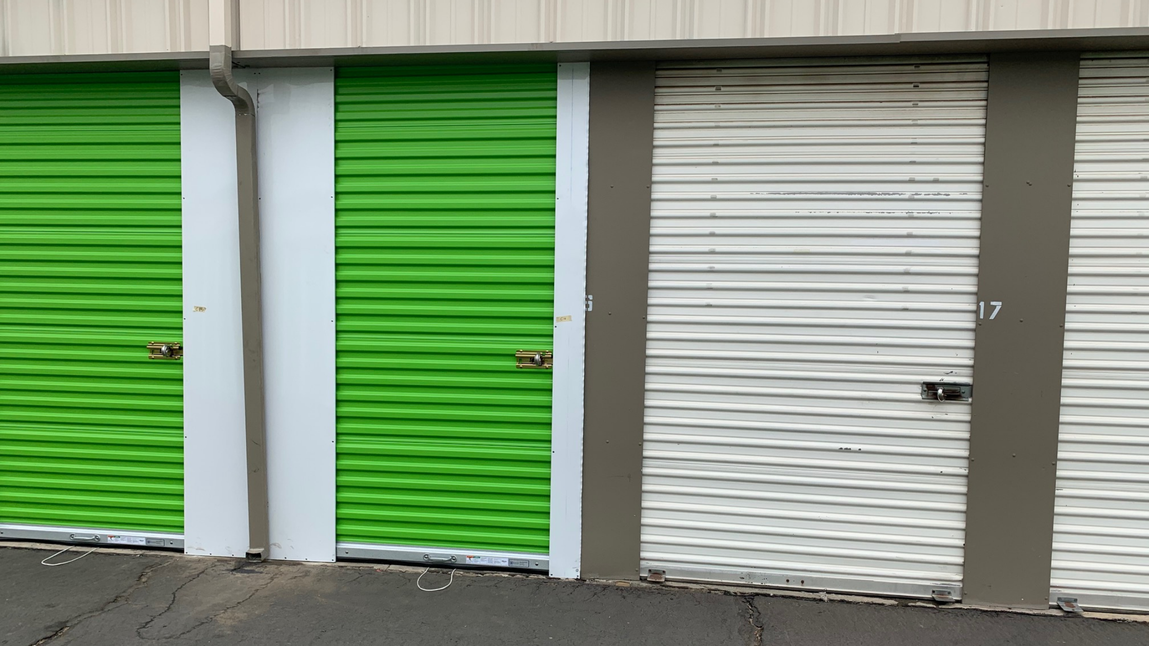 exterior of self storage facility with bright green doors